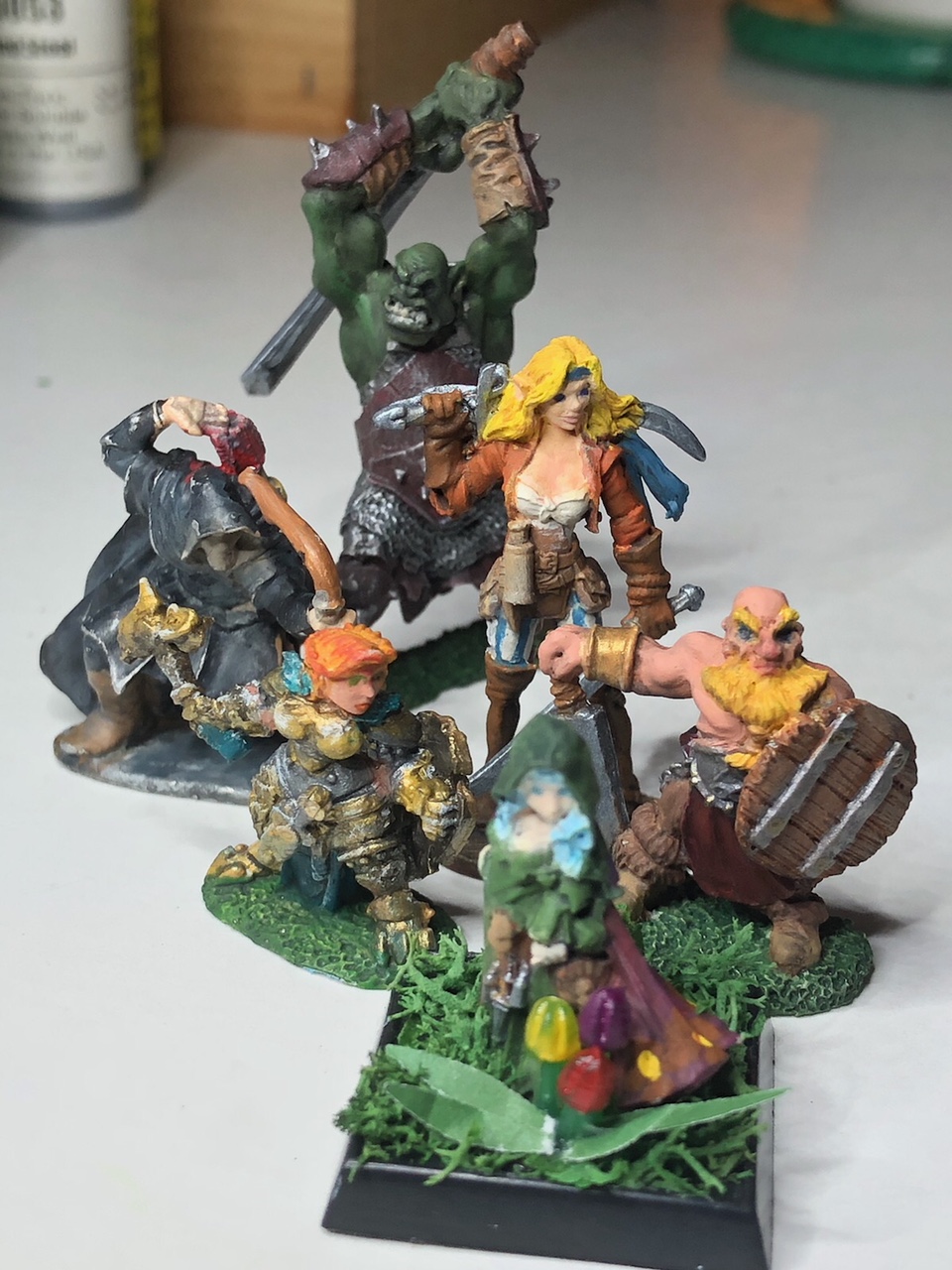 Painted miniatures of a gnome barbarian and his companions